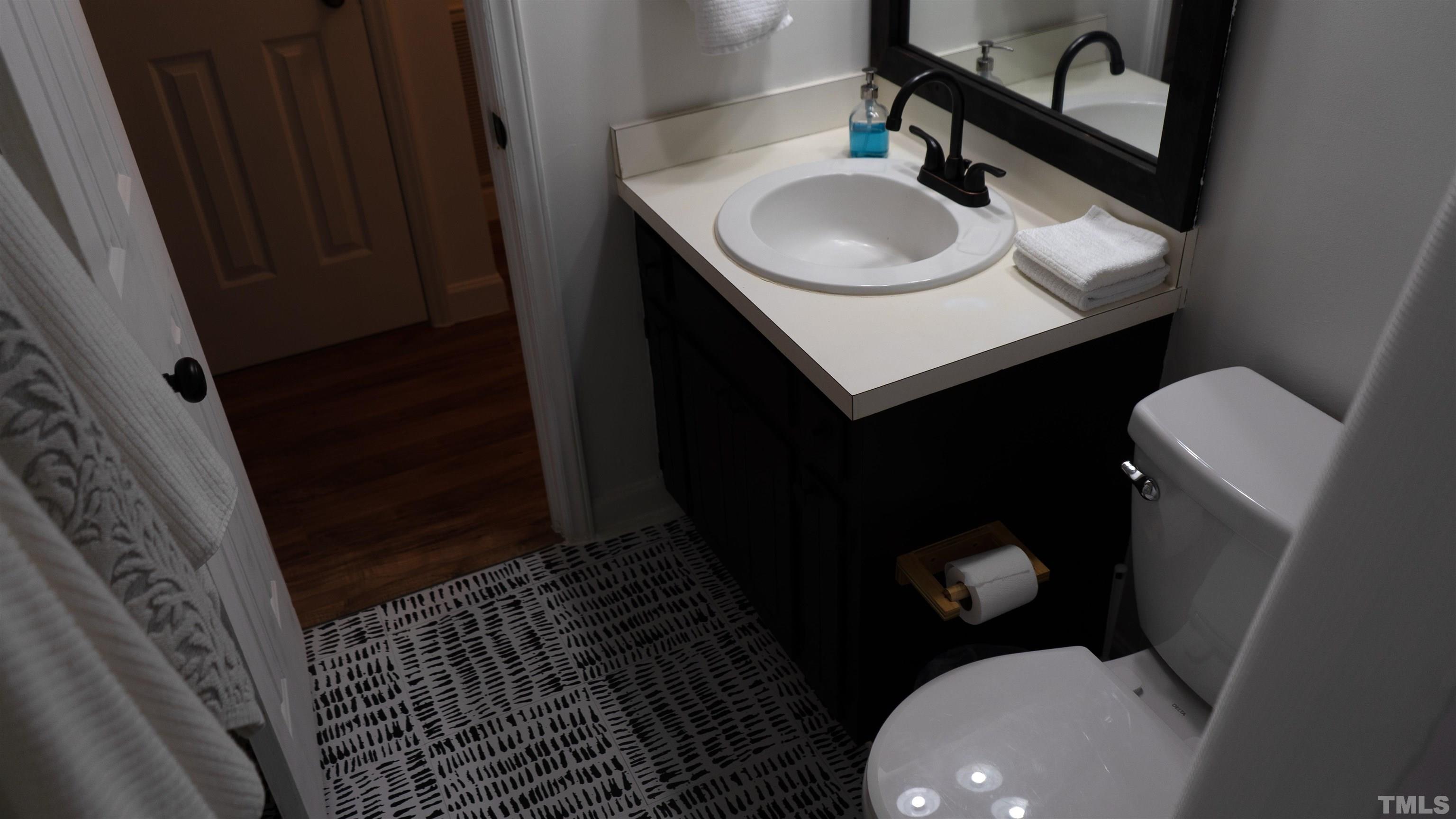 7921 Mandrel Way Raleigh, NC 27616 - Photo 25 of 32 a bathroom with a sink a toilet and a mirror
