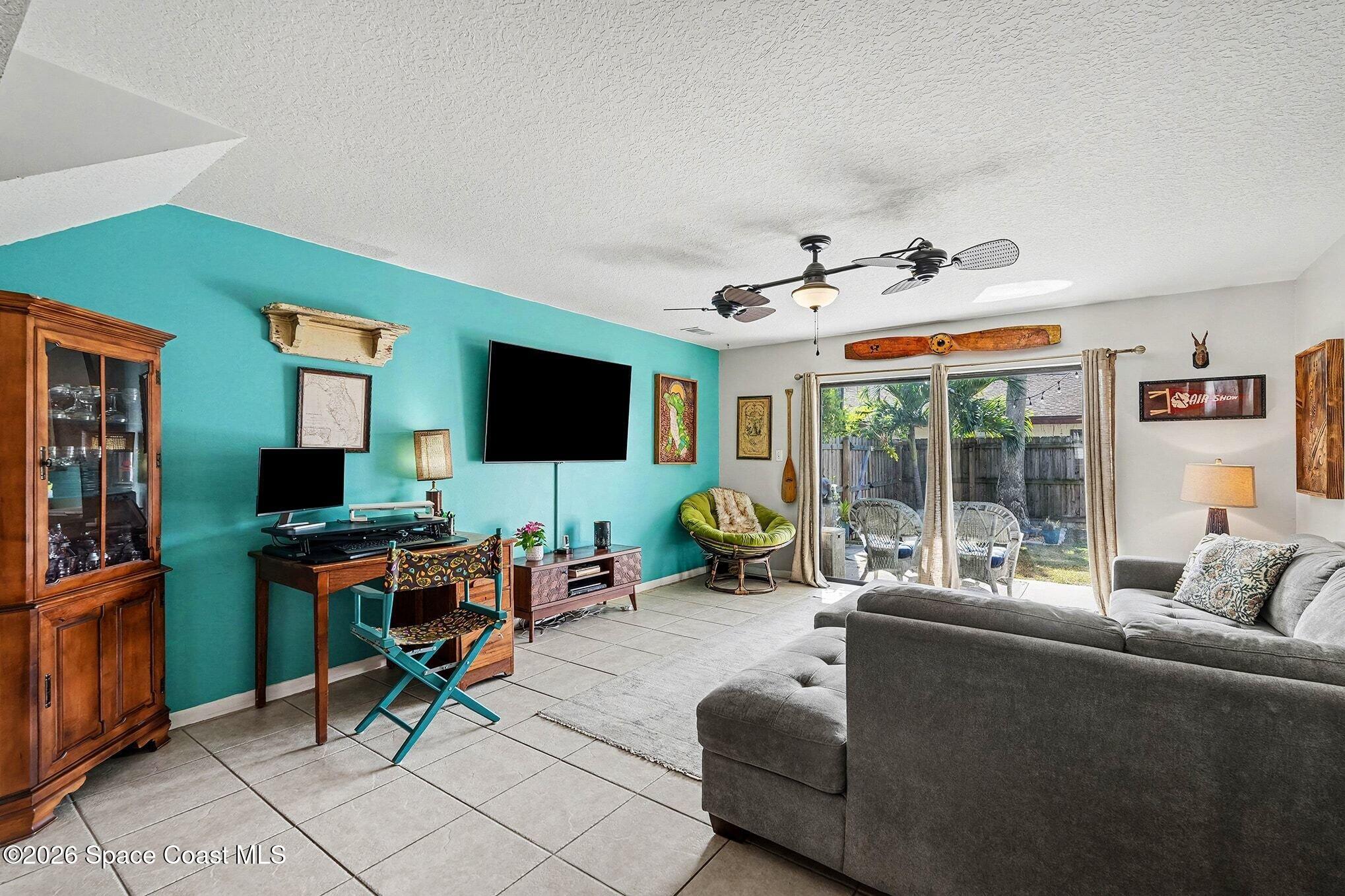 290 North 2nd Street, Unit 3 Cocoa Beach, FL 32931 - Photo 11 of 31 a living room with furniture and a flat screen tv