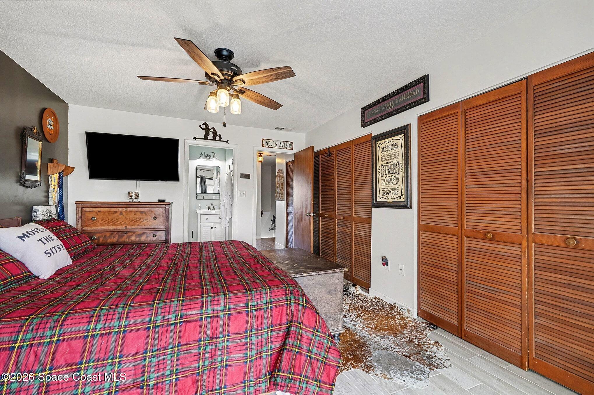 290 North 2nd Street, Unit 3 Cocoa Beach, FL 32931 - Photo 20 of 31 a bedroom with a bed and a flat screen tv