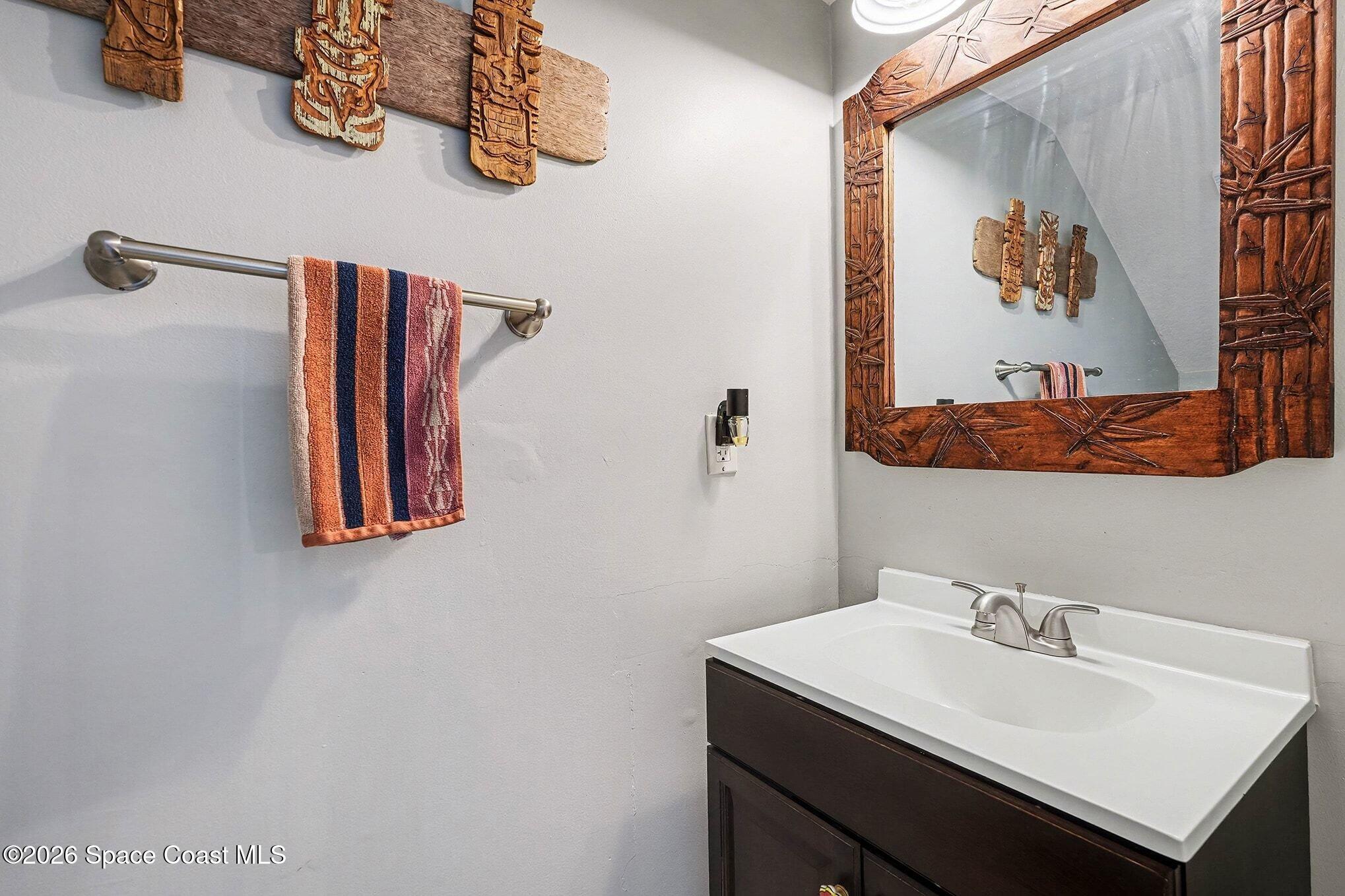 290 North 2nd Street, Unit 3 Cocoa Beach, FL 32931 - Photo 29 of 31 a bathroom with a sink and a mirror