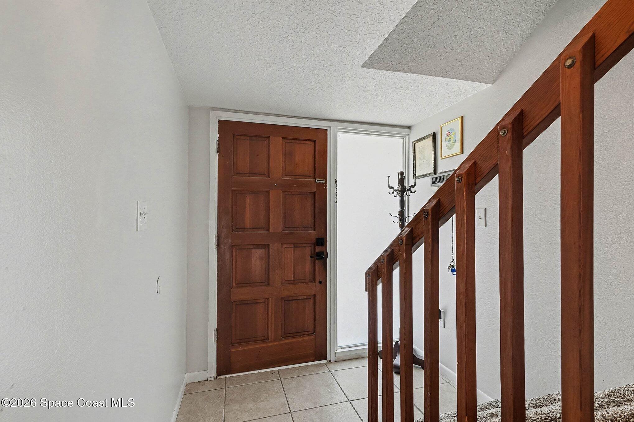 290 North 2nd Street, Unit 3 Cocoa Beach, FL 32931 - Photo 4 of 31 a view of an entryway with staircase