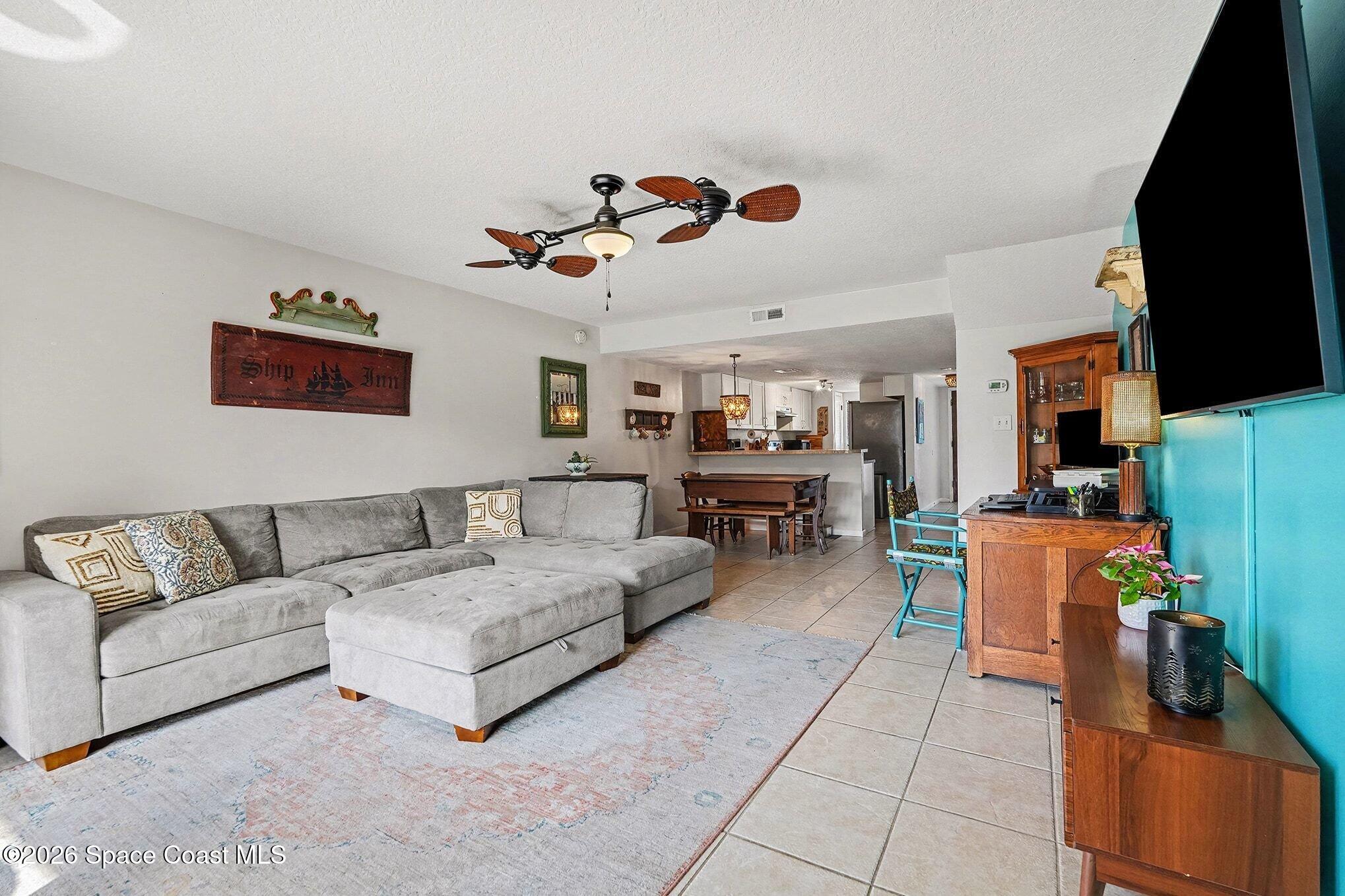 290 North 2nd Street, Unit 3 Cocoa Beach, FL 32931 - Photo 7 of 31 a living room with furniture and a flat screen tv