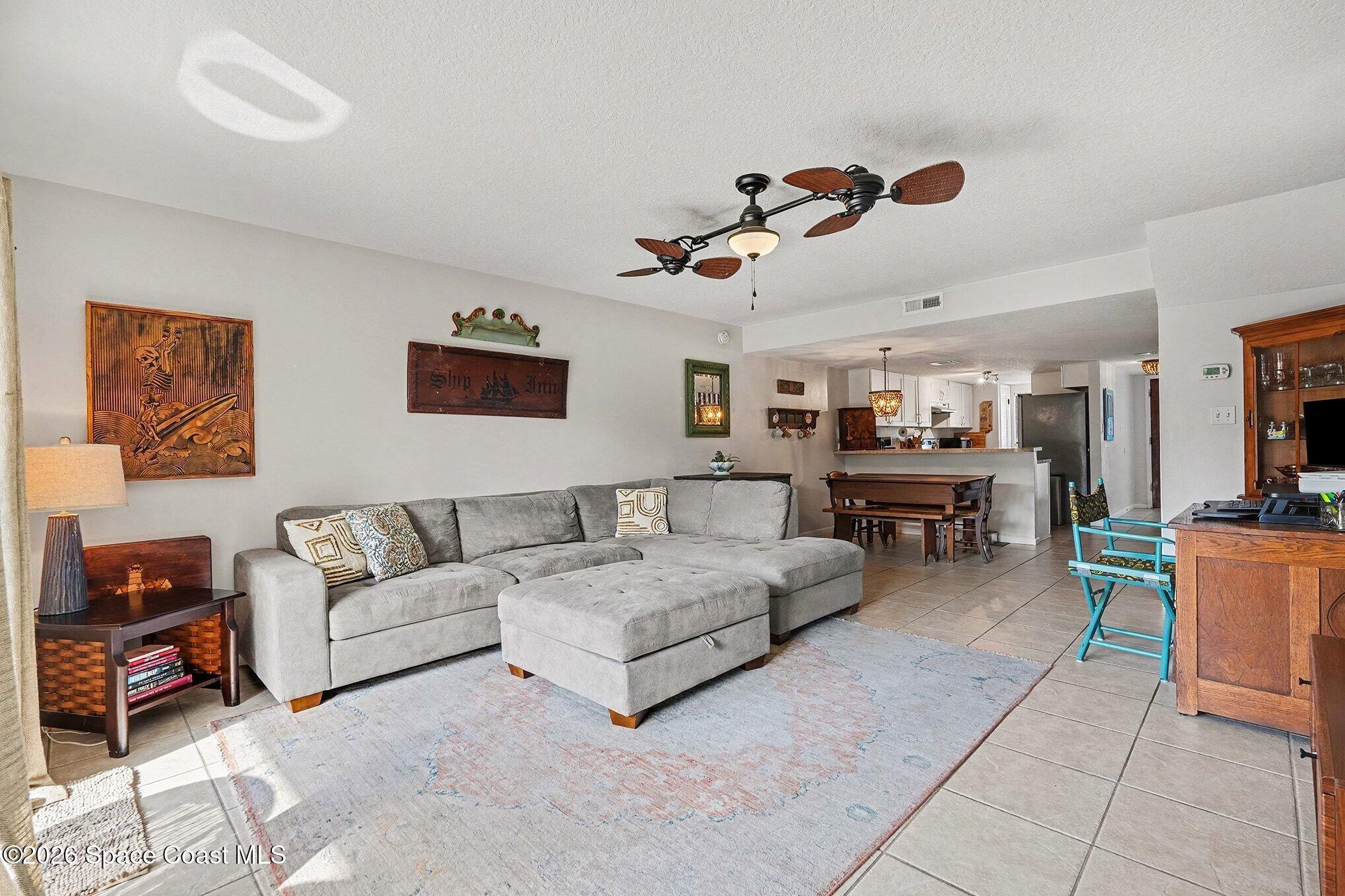 290 North 2nd Street, Unit 3 Cocoa Beach, FL 32931 - Photo 10 of 31 a living room with furniture and a flat screen tv