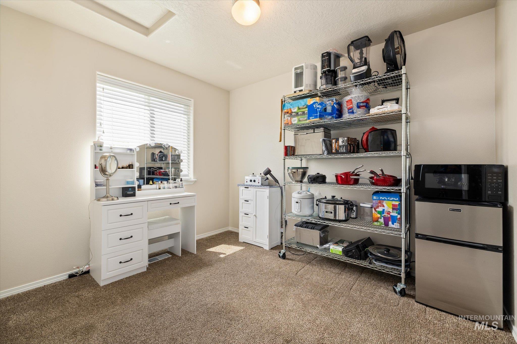 5401 Barkley Way Caldwell, ID 83607 - Photo 6 of 35 Carpeted room featuring a single window with blinds, a white built-in vanity with drawers, a recessed ceiling detail, and an overhead light fixture