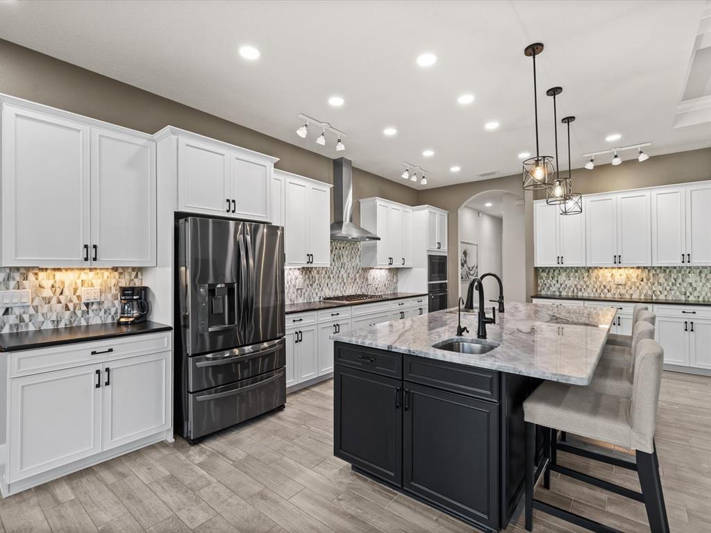 11981 Robina Road Weeki Wachee, FL 34614 - Photo 16 of 93 a kitchen with granite countertop a sink cabinets and stainless steel appliances