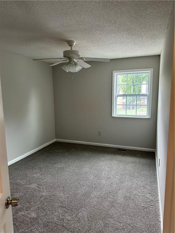 1923 Cheatham Woods Drive Southwest Marietta, GA 30008 - Photo 11 of 20 an empty room with a window and a ceiling fan