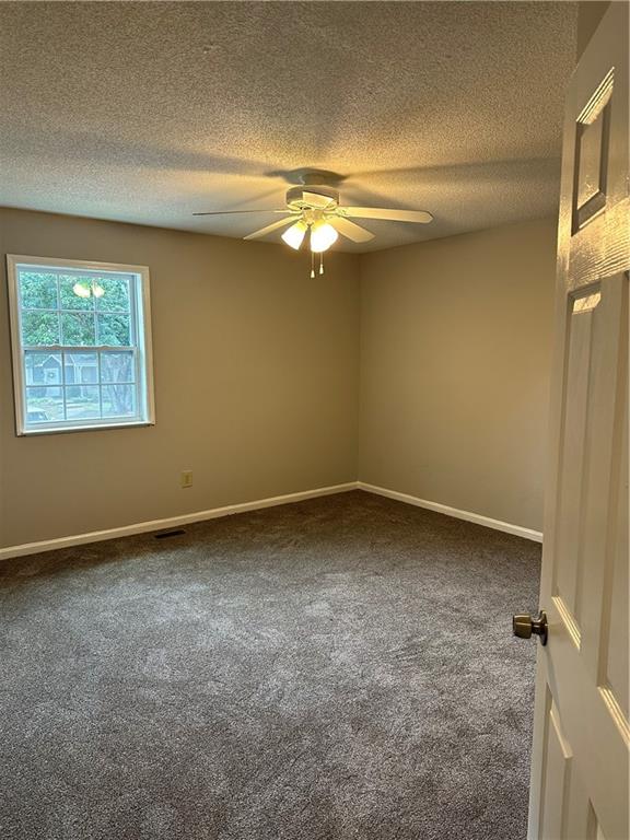 1923 Cheatham Woods Drive Southwest Marietta, GA 30008 - Photo 12 of 20 an empty room with a fan & a window