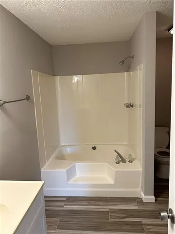 a bathroom with a bathtub and a shower
