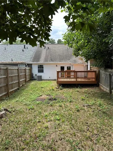 a view of a house with a yard and deck