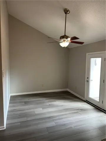 a view of a room with wooden floor and white walls