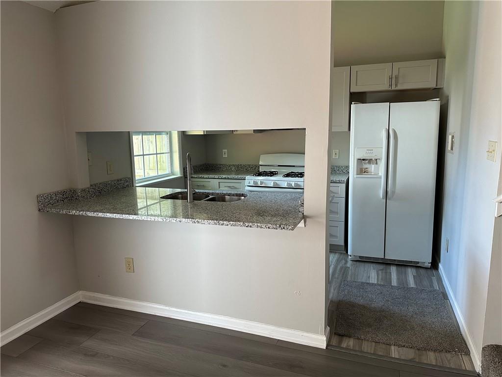 1923 Cheatham Woods Drive Southwest Marietta, GA 30008 - Photo 6 of 20 a kitchen with a refrigerator and a stove top oven