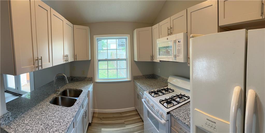 1923 Cheatham Woods Drive Southwest Marietta, GA 30008 - Photo 8 of 20 a kitchen with granite countertop a refrigerator and a stove
