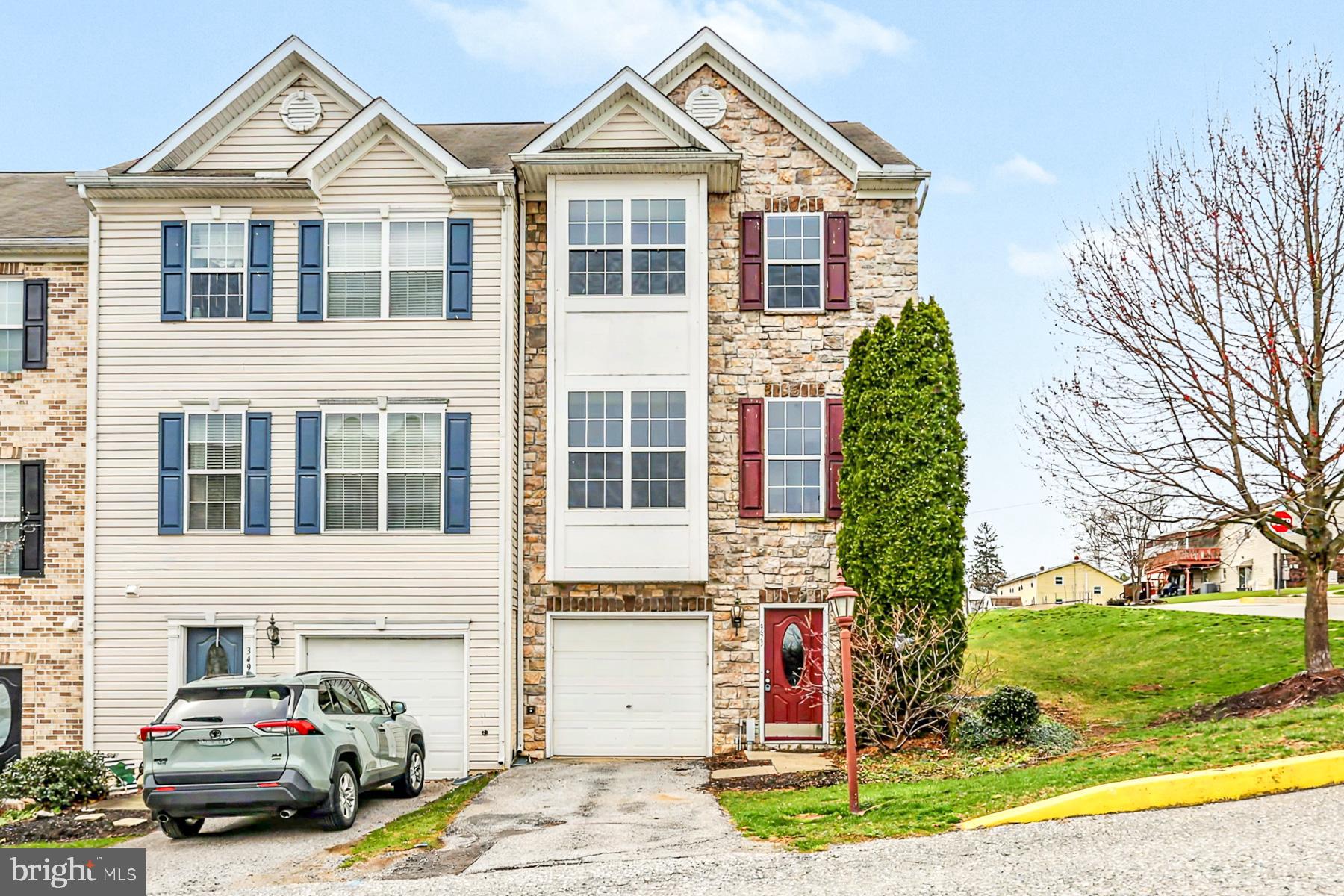 353 West Chestnut Street, Unit 16 Dallastown, PA 17313 - Photo 1 of 27 a front view of a house with a yard and garage
