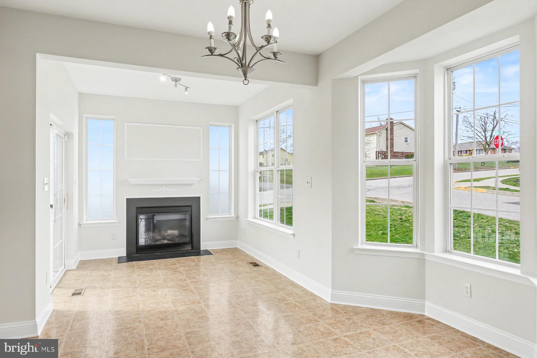 353 West Chestnut Street, Unit 16 Dallastown, PA 17313 - Photo 12 of 27 a view of an empty room with a fireplace and a window