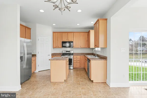 a kitchen with a refrigerator and a sink