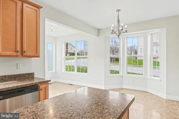 a kitchen with stainless steel appliances granite countertop a stove and a refrigerator