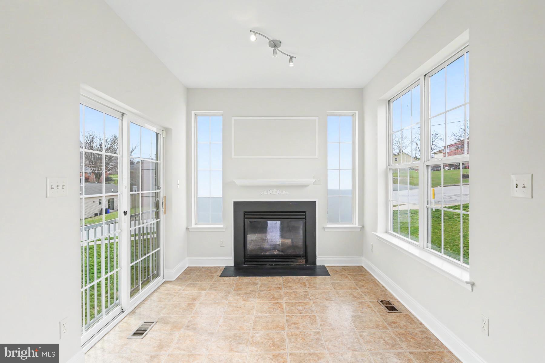 353 West Chestnut Street, Unit 16 Dallastown, PA 17313 - Photo 17 of 27 a view of an empty room with a window and a fireplace