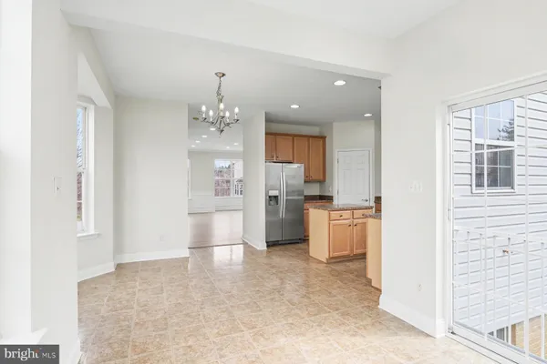 a view of a kitchen with refrigerator and window