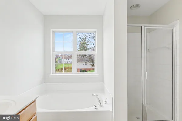 a white bath tub sitting next to a window