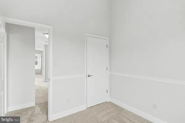 an empty room with windows and entrance