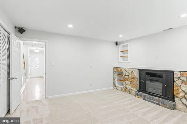 a view of empty room with a fireplace