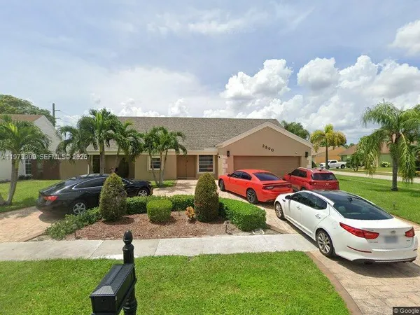 a front view of a house with a garden and deck