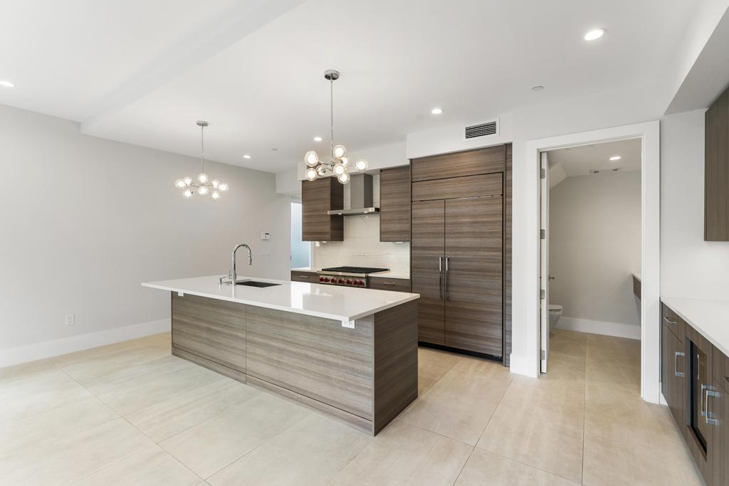 53 Southeast Seminole Street, Unit A Stuart, FL 34994 - Photo 18 of 75 a large kitchen with a sink stainless steel appliances and cabinets