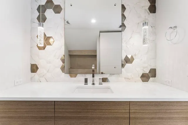 a bathroom with a sink a mirror and a shower