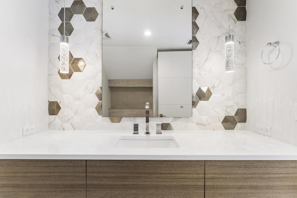 53 Southeast Seminole Street, Unit A Stuart, FL 34994 - Photo 25 of 75 a bathroom with a sink and a mirror