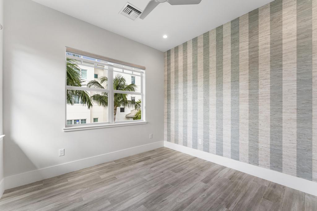 53 Southeast Seminole Street, Unit A Stuart, FL 34994 - Photo 47 of 75 wooden floor in an empty room with a window