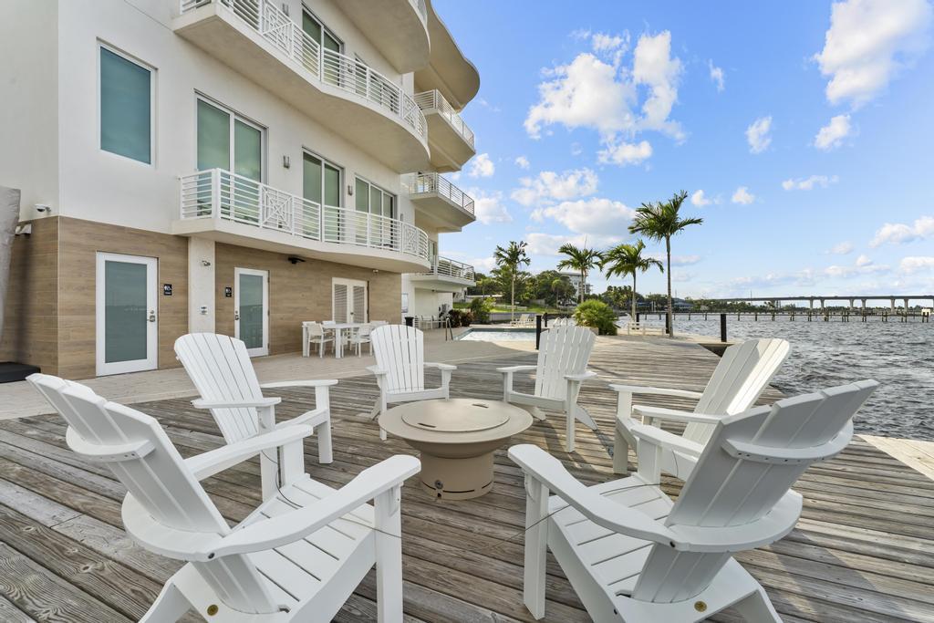 53 Southeast Seminole Street, Unit A Stuart, FL 34994 - Photo 65 of 75 a view of a patio with table and chairs and potted plants