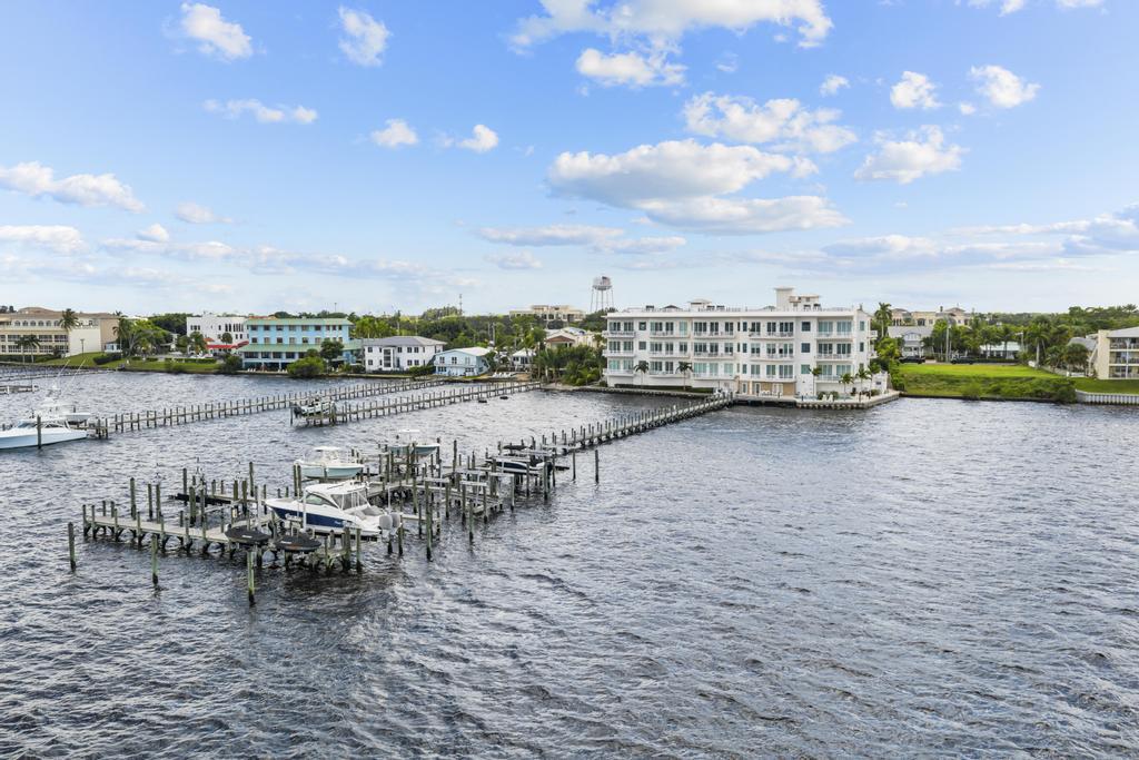 53 Southeast Seminole Street, Unit A Stuart, FL 34994 - Photo 73 of 75 a view of a lake with outdoor seating