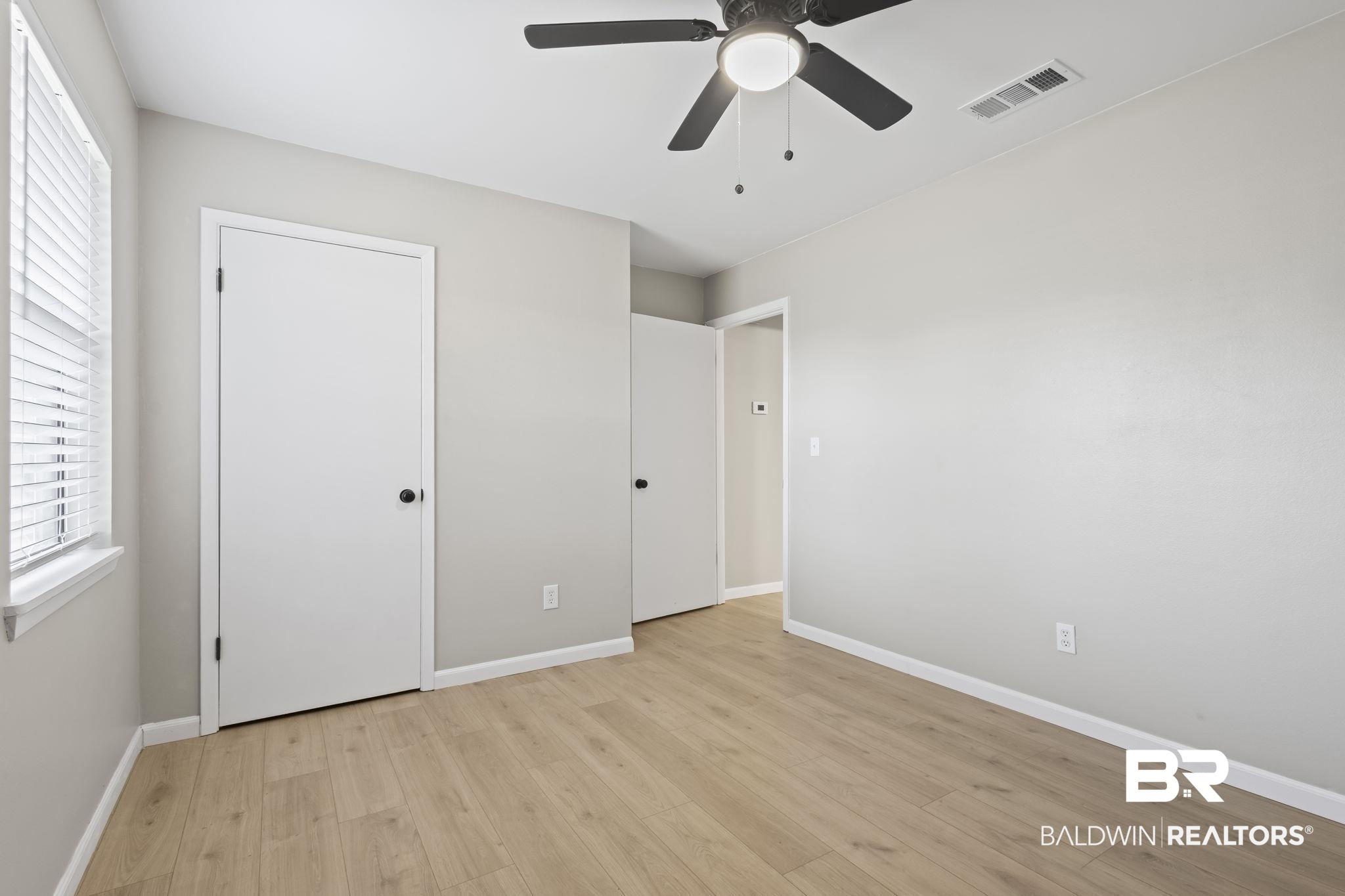 309 West Roosevelt Avenue Foley, AL 36535 - Photo 39 of 60 Unfurnished bedroom with ceiling fan and light wood-type flooring