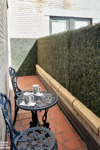 a view of a back yard from a balcony