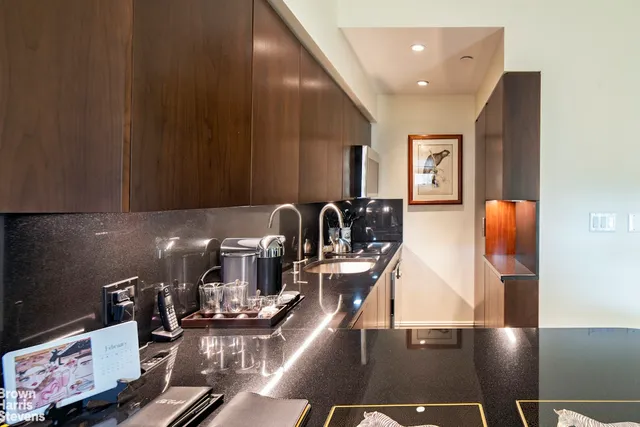 a kitchen with a sink cabinets and appliances