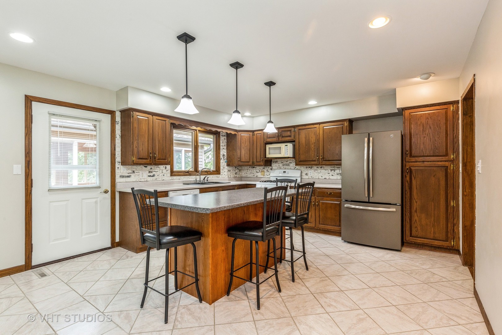 41W723 Lenz Road Elgin, IL 60124 - Photo 5 of 41 a kitchen with refrigerator a sink and chairs