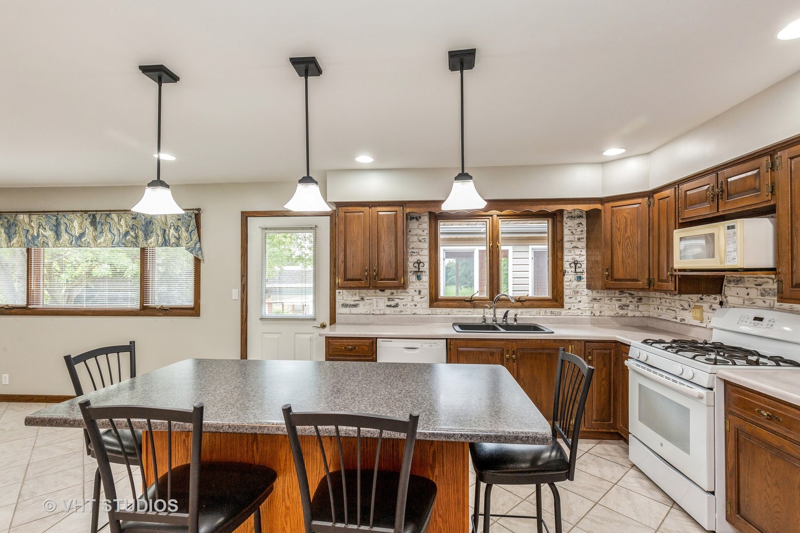 41W723 Lenz Road Elgin, IL 60124 - Photo 8 of 41 a kitchen with stainless steel appliances granite countertop a stove a refrigerator a kitchen island a sink dishwasher with a dining table and chairs