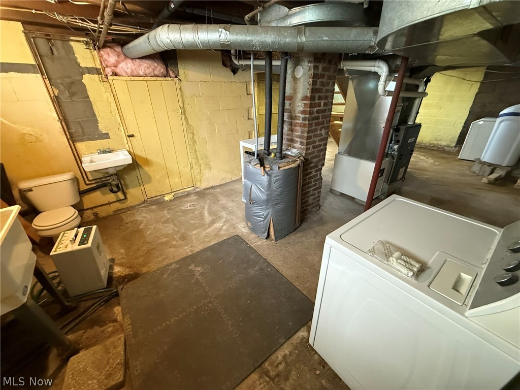 6784 Old Zoarville Road Northeast Dover, OH 44622 - Photo 39 of 50 Unfinished basement featuring washer / dryer and heating unit