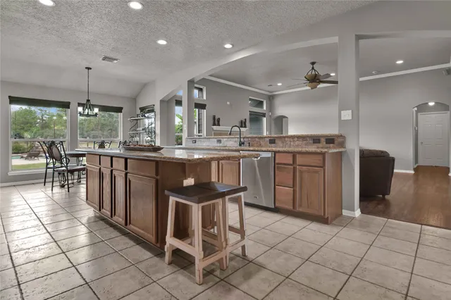 a kitchen with stainless steel appliances granite countertop a refrigerator and a stove top oven