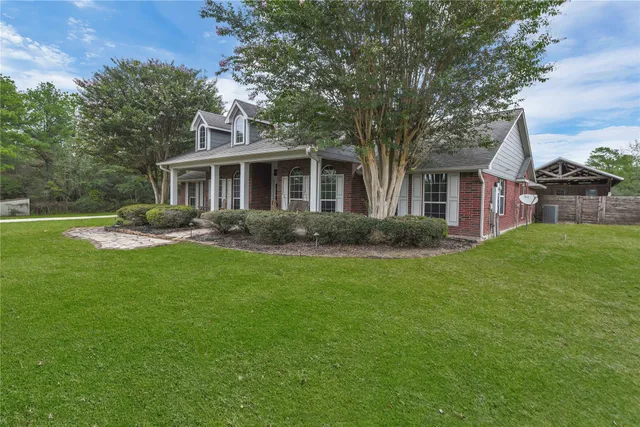 a front view of house with yard and green space