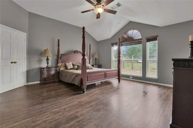 a bedroom with furniture and wooden floor