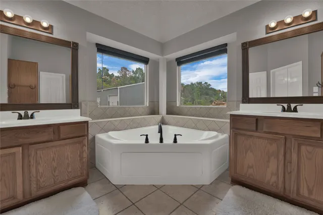 a bath tub sitting in a bathroom next to a window