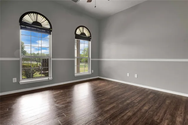 a bedroom with a bed window and a chandelier