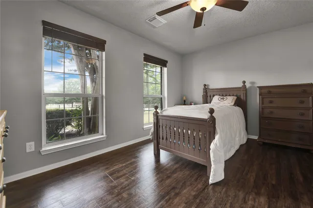 a bathroom with a granite countertop shower a toilet and a sink