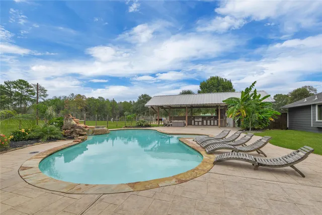 a view of a swimming pool with a yard