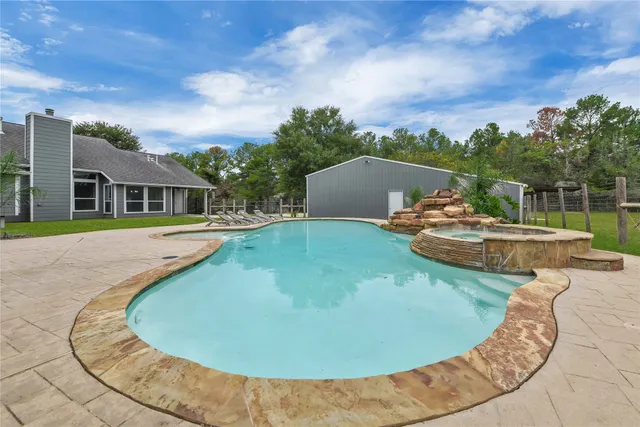 a view of a backyard with swimming pool