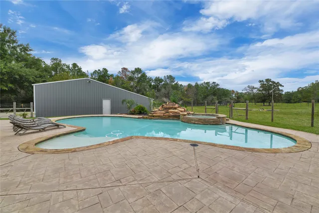 a view of a house with swimming pool and sitting area