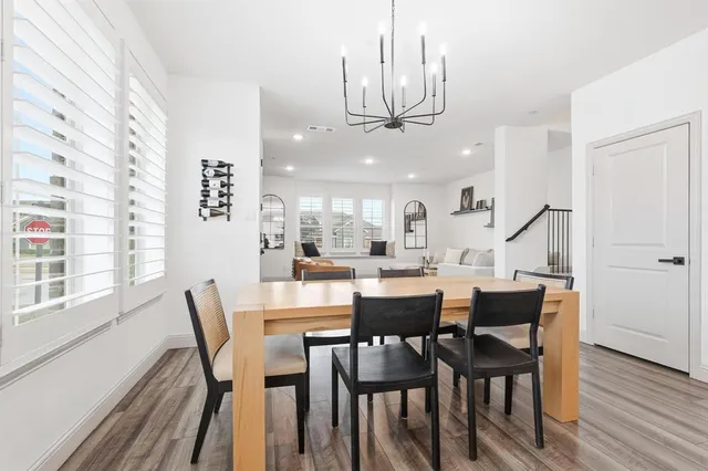 a view of a dining room with furniture wooden floor and chandelier