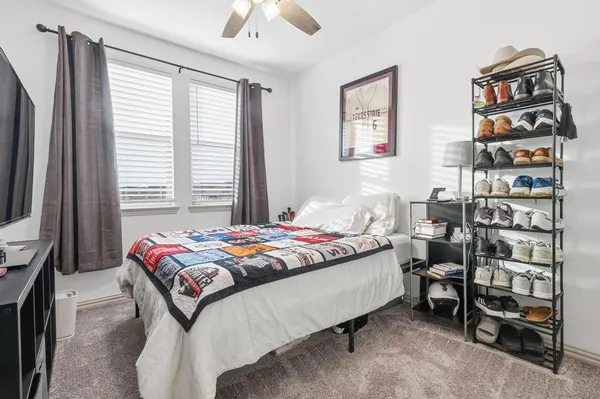 a bedroom with a bed and a book shelf