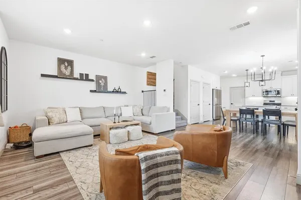a living room with furniture and a wooden floor